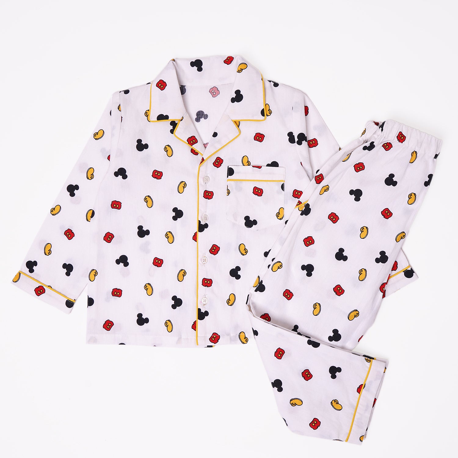 A set of kids' pajamas in white with a pattern of Mickey Mouse heads and ears, a long-sleeved top with a button-down front and matching pants.