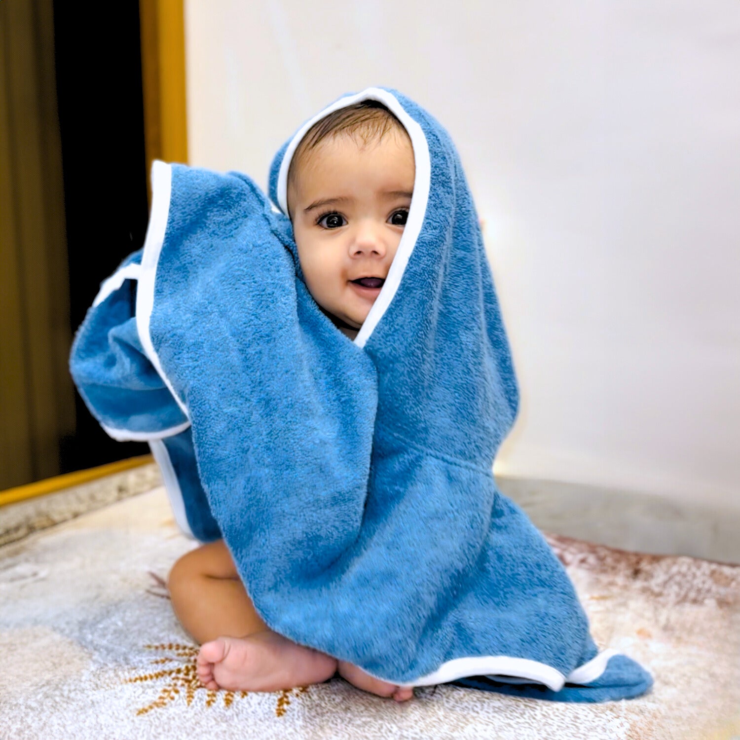 Baby wrapped in a dark blue bath towel