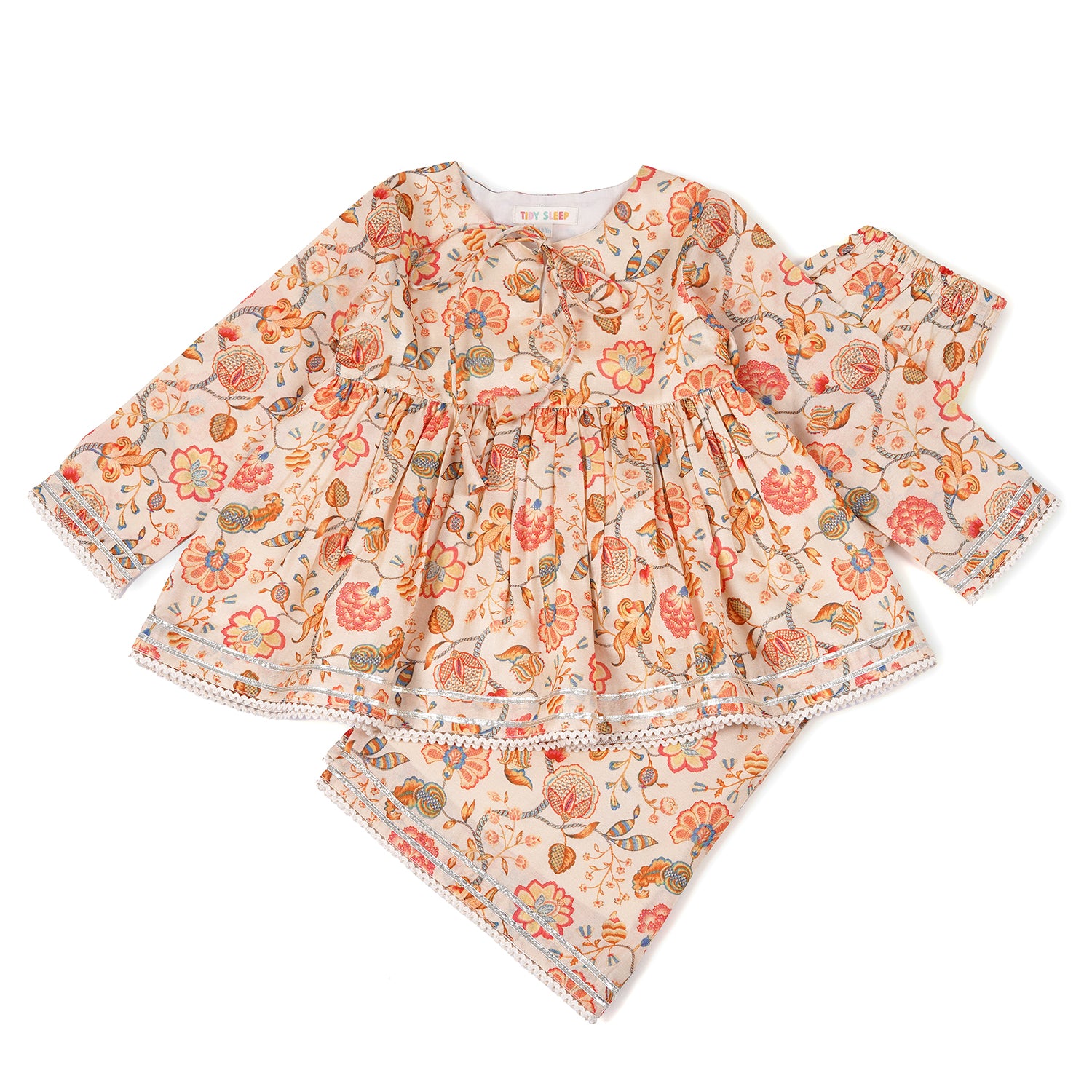 A set of baby clothes in a peach and cream floral pattern, a long-sleeved top with a ruffled skirt and a matching pair of pants