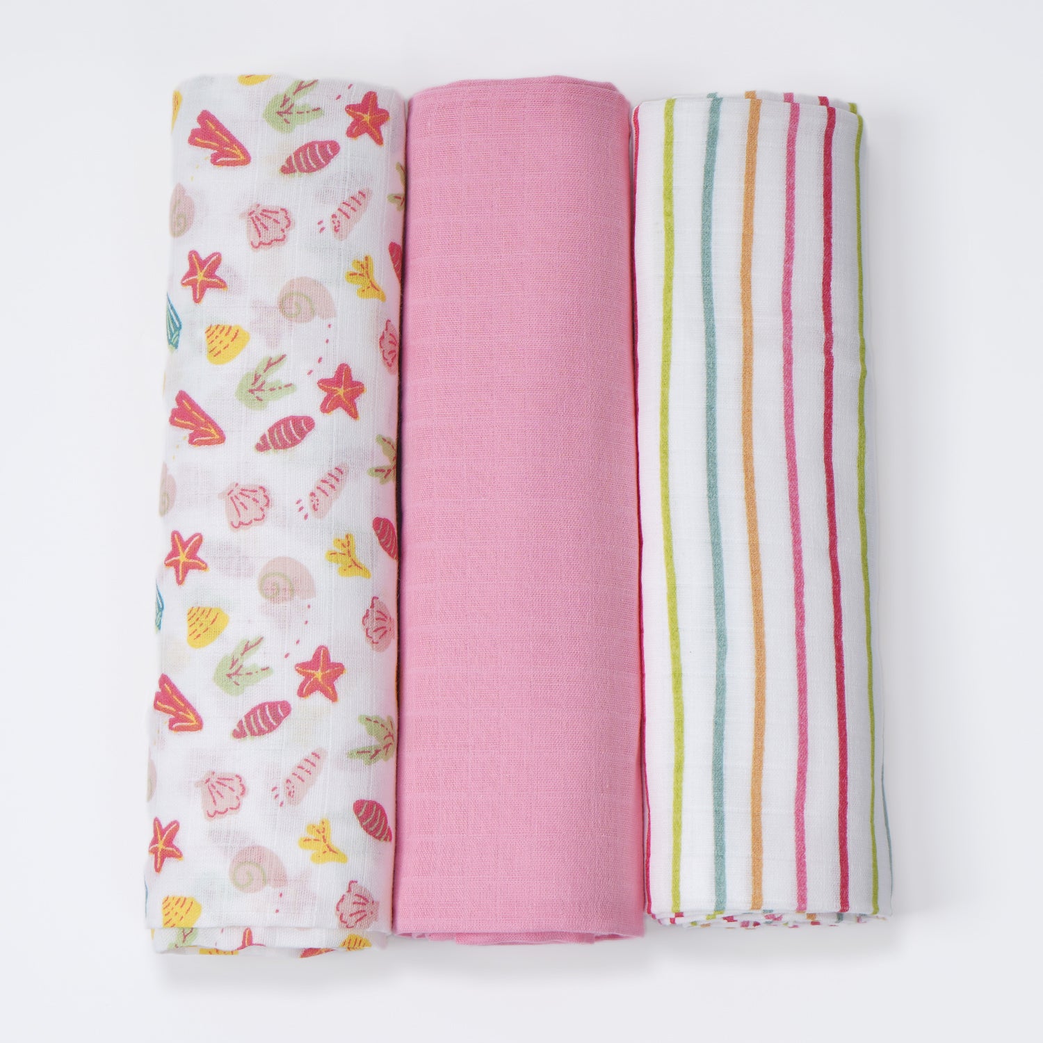 Three rolled changing mats in white and pink color, featuring patterns of lines, stars, and some other things.